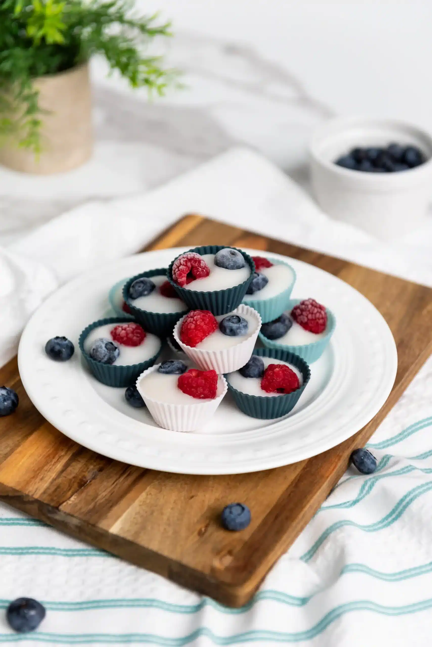frozen yogurt cups with raspberries and blueberries on top
